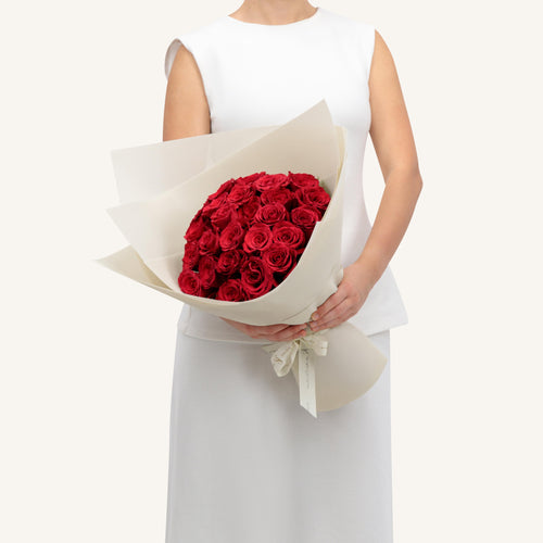 Bouquet of red roses wrapped in white paper — Roses Only Winnipeg